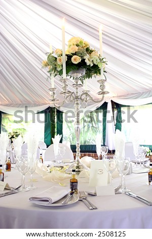 Dinner table setting at a banquet with roses on a chandelier 2