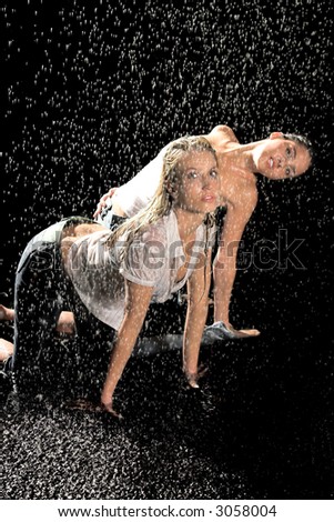Two woman in the rain with wet shirts