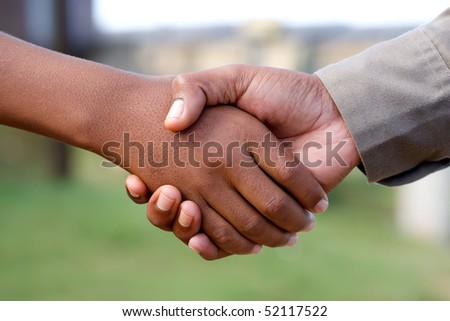 Two men shaking hands outdoors