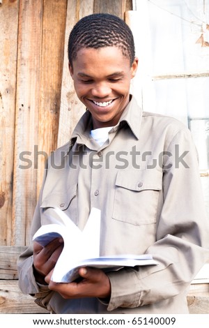 Friendly black student paging through his book.