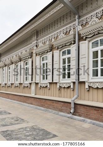 Facade with windows and wood carvings old wooden house made in the Russian tradition in a country town