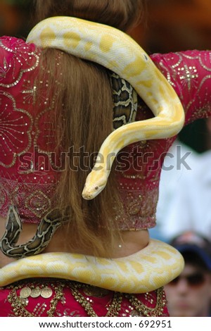 Dancer performs with a python companion draped around her neck