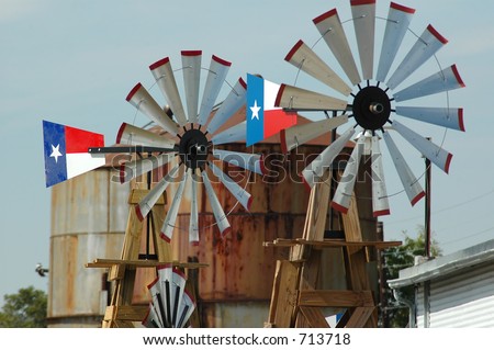A pair of windmills with the Texas flag painted on their tails.