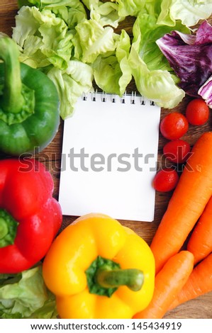 Open note book ready for writing recipe with food ingredients