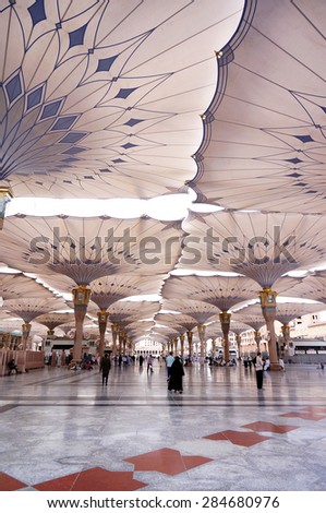 MEDINA, SAUDI ARABIA-CIRCA MAY 2015: Pilgrims walk underneath giant canopies in Nabawi Mosque on MAY, 2015 in Medina, Saudi Arabia .The Nabawi mosque is the second holiest mosque in Islam.