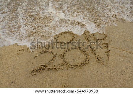 Happy New Year 2017 replace 2016 year concept on the beach