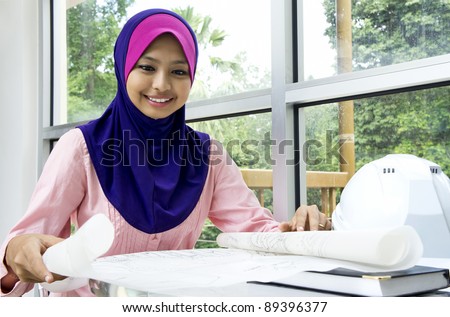 Young Muslim architect-woman in the office