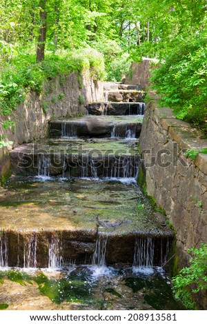 Land-art-park, landscaping with plant, pond and waterfall
