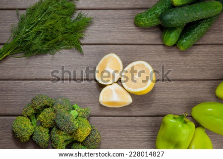 Green fresh vegetables and spice on wooden background