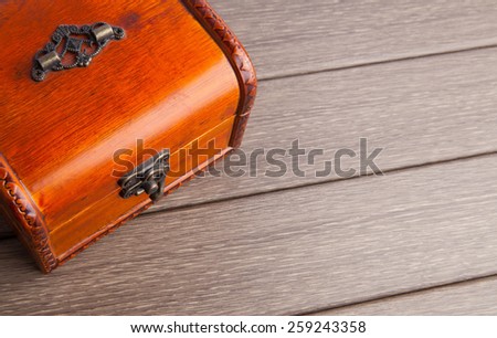 Wooden chest with metallic trim on background