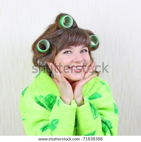 beautiful girl in green dressing gown with rollers hair