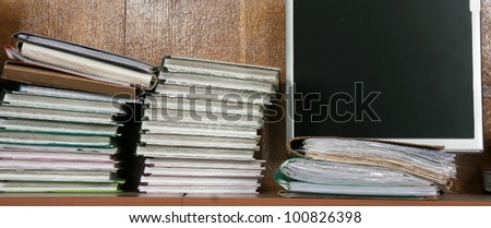 Books and folders with documents at the monitor