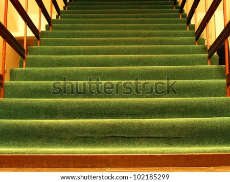 Green carpet on the stairs in the hotel lobby