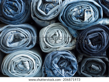 Roll blue denim jeans arranged in stack