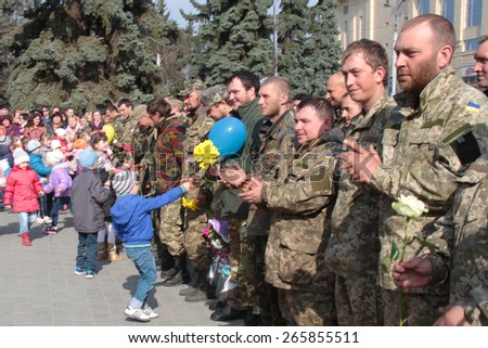 LUTSK, UKRAINE - MARCH 27, 2015: Children welcome soldiers who returned home from the zone of military operations in eastern Ukraine