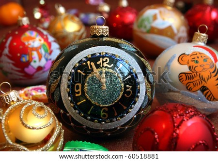 Christmas spheres. Shallow depth of field. Focus on the central sphere of black color with the drawn hour dial