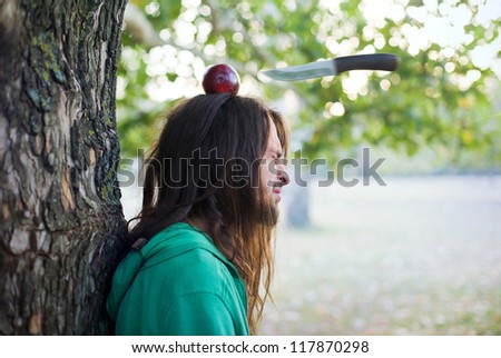 Throwing knife into apple on a guy's head