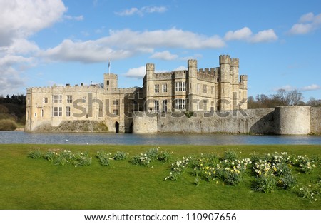 Leeds Castle in Kent, United Kingdom. Frontal view with blooming daffodils.