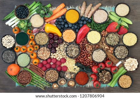 Liver detox super food with fruit, vegetables, herbs, spices,legumes, nuts, seeds, grains, cereals and herbal medicine. Health foods high in antioxidants, vitamins  & fibre.  Top view on bamboo & oak.