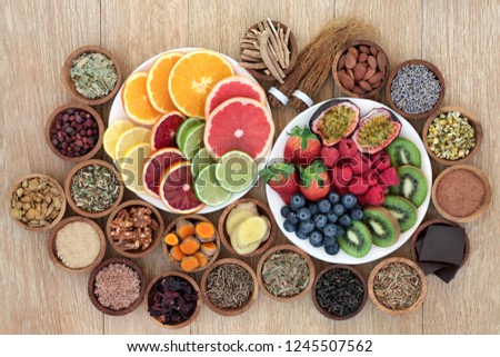 Stress and anxiety relieving health foods, herbs, spices and supplement powders that also help relaxation and reduce chronic fatigue and depression. Top view on oak wood table.