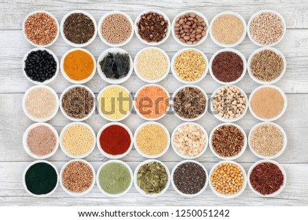 Liver detox health food selection in porcelain bowls on rustic wood background. Foods high in antioxidants, anthocaynins, vitamins, dietary fibre and smart carbohydrates.