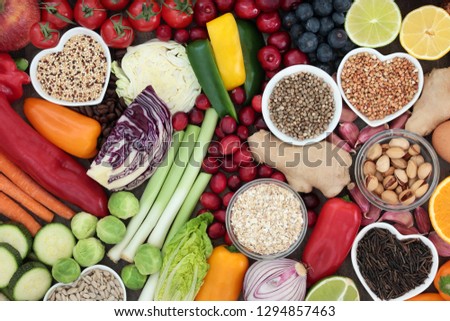 Super food concept for healthy diet with seeds, nuts, fruit, vegetables, cereal, herbs, and grains. Foods high in antioxidants, protein, anthocyanins, dietary fibre and vitamins. Top view.