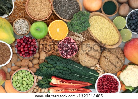 Health food for a high fibre diet with fruit, vegetables, whole grain bread rolls, grains, whole wheat pasta, nuts, seeds and spirulina powder. High in antioxidants, anthocyanins & vitamins.