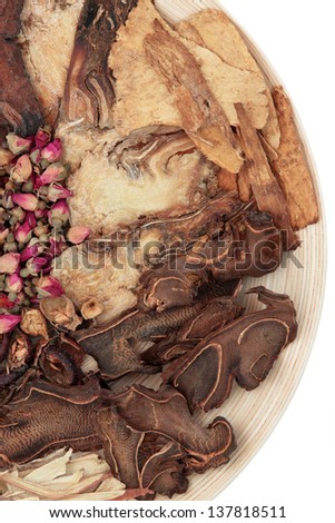 Chinese traditional herbal medicine selection on a wooden bowl over white background.