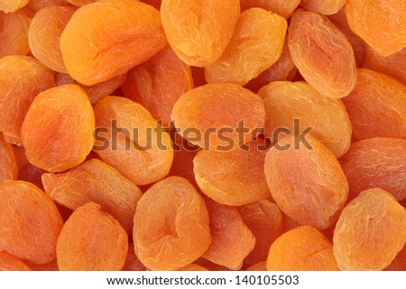 Dried apricot fruit forming a background.