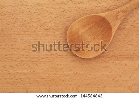 Beech wood spoon and board forming a background