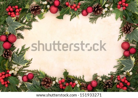 Christmas floral background border with red bauble decorations, holly, ivy and mistletoe over old parchment.
