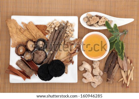 Traditional chinese herbal medicine selection with honey over bamboo.