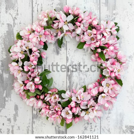 Apple Flower Blossom Wreath Over Old Distressed Wooden Background.