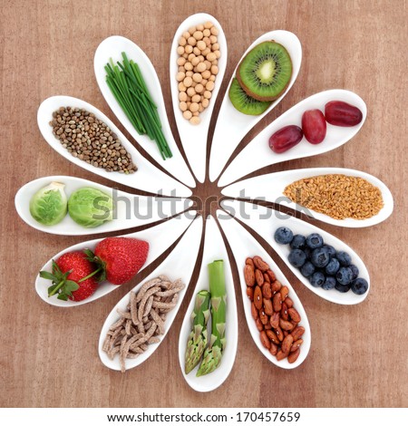 Super food health food selection in white bowls over papyrus background.