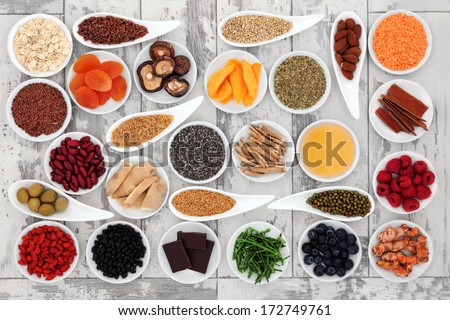 Healthy Super Food Selection In Porcelain Bowls Over Distressed Wooden Background.