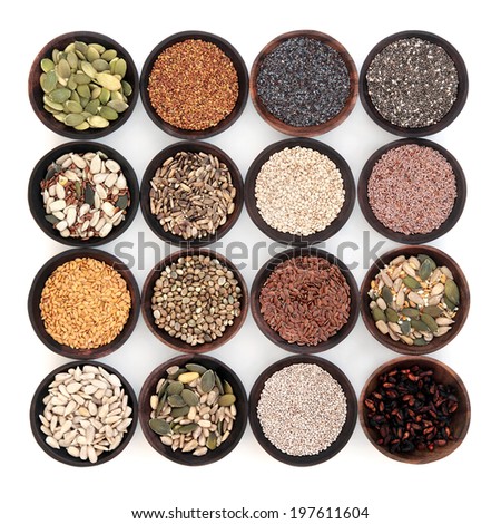 Seed super food selection in wooden bowls over white background.