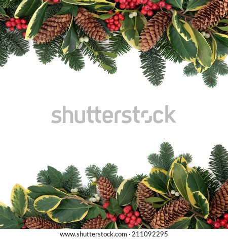 Christmas and winter background floral border with holly, ivy, mistletoe, pine cones and fir over white with copy space.