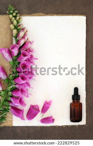Foxglove flower border with medicinal dropper bottle on a natural hemp notebook and brown paper background. Digitalis pupurea.