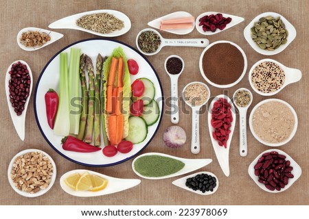 Large weight loss diet health food selection in porcelain bowls and measuring spoons over brown paper background.