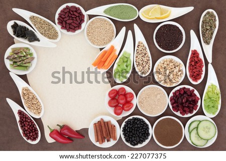 Large weight loss diet health food selection in porcelain bowls over parchment and brown paper background.