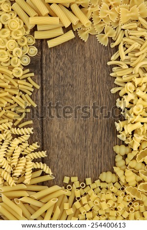 Pasta food abstract background border over old oak wood.