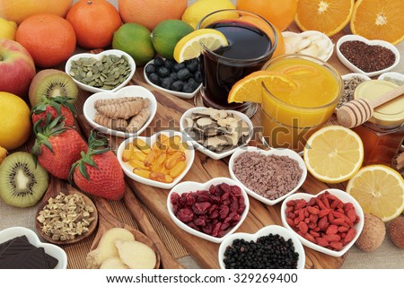 Super food selection for cold and flu remedy including foods high in vitamin c and antioxidants with herbal medicine and supplement capsules.