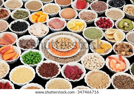 Large health and body building high protein super food of meat, fish, dairy, pulses, cereals, grains, seeds, supplement powders, fruit, vegetable  selection. Selective focus.