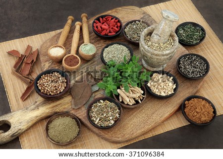 Herb and spice health food selection for men in wooden bowls and spoons. Used in natural alternative herbal medicine.