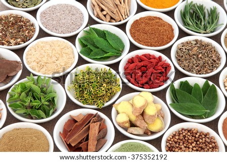 Herb, spice and super food selection for mens health in porcelain bowls over hessian background. Used in natural alternative herbal medicine. Selective focus.