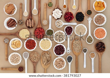 Large superfood sampler for good health in spoons and bowl forming an abstract background. Highly nutritious in antioxidants, vitamins, minerals and dietary fiber.
