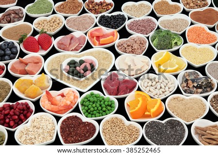 Large body building and health high protein super food with meat, fish, dairy, pulses, cereals, grains, seeds, supplement powders, vitamin pills, fruit and vegetable  selection. Selective focus,