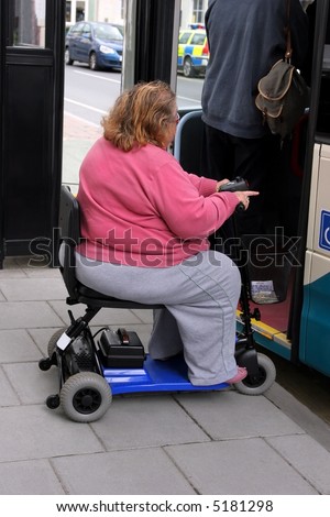 Overweight disabled female on an electric three wheeler mobility scooter waiting in line to get onto a bus