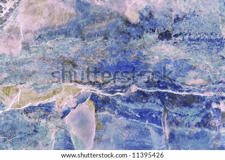 Abstract marble pattern on slate, in various shades of blue and pink.
