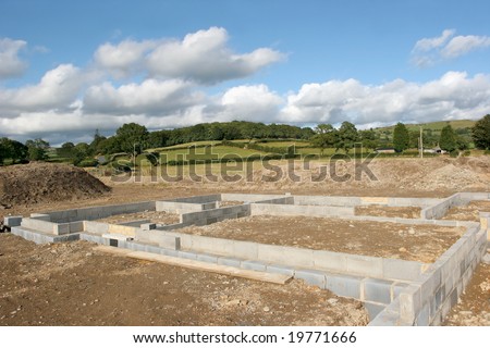 Concrete  block foundations for a new building on a construction site in rural countryside.
